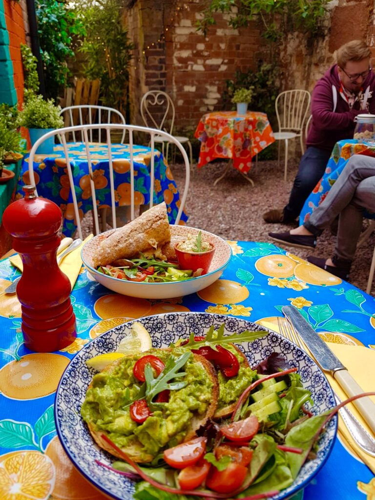 Salad and baguette lunch on a table in the courtyard